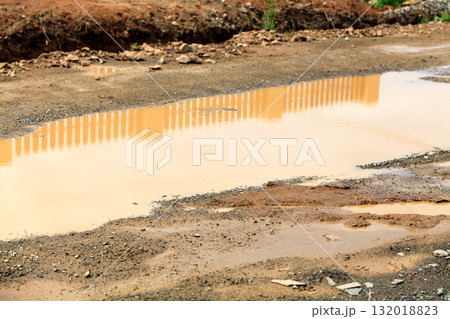 Large puddle on a dirty road Large puddle on a dirty road 132018823