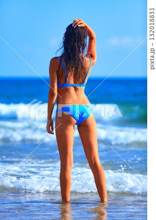 Sexy gorgeous woman with beautiful slim body is posing on a sandy sea beach, summer holidays concept, pretty girl Sexy gorgeous woman with beautiful slim body is posing on a sandy sea beach, summer holidays concept, pretty girl 132018831