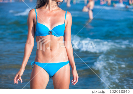 Sexy gorgeous woman with beautiful slim body is posing on the sea or ocean beach, summer holidays concept 132018840