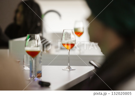 Preparation for Beer Tasting, Poured Alcoholic Drinks to Glasses on Table. 132020805