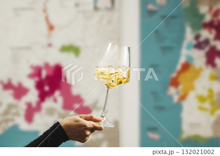 Swirling White Wine in Glass Against Wine Map Backdrop 132021002