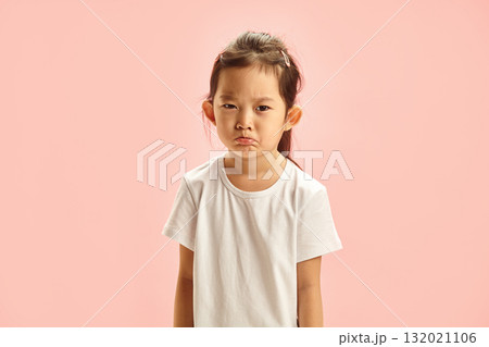 Frustrated Little Asian Girl Pursing her Lips from Resentment with a Gloomy Expression on Face Resentment Looking to Camera does Not Agree with Someone's opinion, Sighs Angrily, Having Bad Mood Frustrated Little Asian Girl Pursing her Lips from Resentment with a Gloomy Expression on Face Resentment Looking to Camera does Not Agree with Someone's opinion, Sighs Angrily, Having Bad Mood 132021106