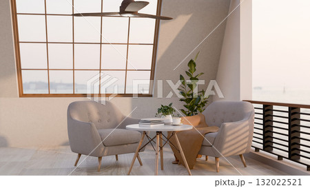 A coffee cup and books on round stool table with fabric armchairs on a terrace of restaurant or cafe 132022521