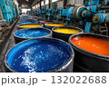 A colorful assortment of dyes are stored in large barrels inside a factory, ready for use in textile production and other industrial applications 132022688