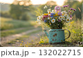 Rustic Flower Vase in Sunlit Garden.Turquoise watering can with wildflowers on grass, glowing in warm sunlight. Perfect for spring, nature, and romantic themes. Rustic Flower Vase in Sunlit Garden.Turquoise watering can with wildflowers on grass, glowing in warm sunlight. Perfect for spring, nature, and romantic themes. 132022715