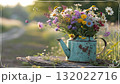 Rustic Flower Vase in Sunlit Garden.Turquoise watering can with wildflowers on grass, glowing in warm sunlight. Perfect for spring, nature, and romantic themes. Rustic Flower Vase in Sunlit Garden.Turquoise watering can with wildflowers on grass, glowing in warm sunlight. Perfect for spring, nature, and romantic themes. 132022716