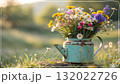 Rustic Flower Vase in Sunlit Garden.Turquoise watering can with wildflowers on grass, glowing in warm sunlight. Perfect for spring, nature, and romantic themes. Rustic Flower Vase in Sunlit Garden.Turquoise watering can with wildflowers on grass, glowing in warm sunlight. Perfect for spring, nature, and romantic themes. 132022726