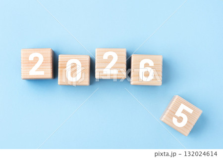 Wooden cubes with numbers of the New Year 2026 on a blue background 132024614