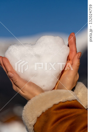 Snow Heart Hands Winter: Romantic snowy landscape, woman holding heart-shaped snowball, winter romance. Snow Heart Hands Winter: Romantic snowy landscape, woman holding heart-shaped snowball, winter romance. 132024759