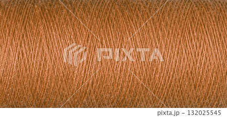macro texture of a skein of orange sewing thread macro texture of a skein of orange sewing thread 132025545