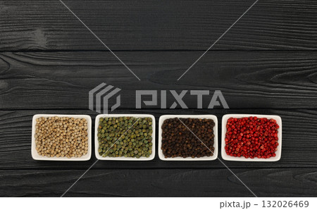 Bowls of assorted peppercorns 132026469