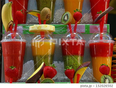 Fresh fruit juices and smoothies on retail shelf 132026502