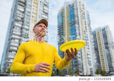 Ai generated Man holding frisbee preparing to throw in urban park sunset 132026984