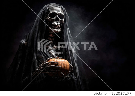 Grim reaper holding pumpkin in the dark 132027177