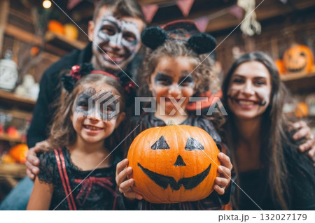 Halloween pumpkins with a happy family in background. 132027179
