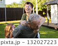 Happy children playing with grandfather in backyard garden on summer holiday 132027223