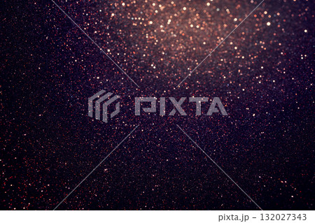 Shimmering deep purple glitter texture detailed below with luminous glow rising at the top 132027343