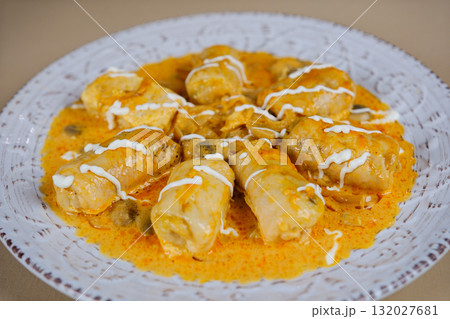 Cabbage rolls sauce Plate with tasty stuffed cabbage rolls and sauce on light wooden background 132027681