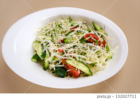 Vegetarian salad. Spring vegan salad with cabbage, cucumber, green onion and parsley. Top view, flat lay, overhead 132027711
