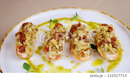 Bruschetta appetizer plate Homemade Italian Tomato Bruschetta on a Plate, top view. Flat lay, overhead, from above. 132027714