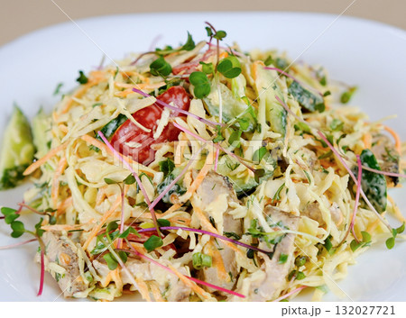 There is salad of chopped fresh vegetables on plate. Dish is made from salad pim , cabbage, bell pepper, corn and seasoned with mayonnaise 132027721