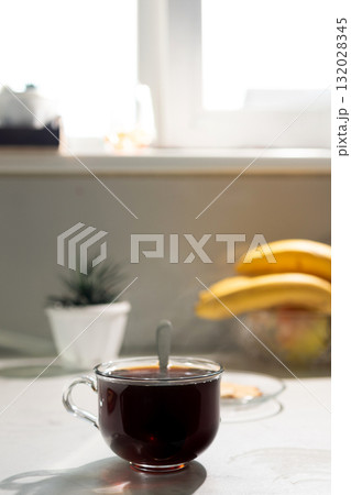Cup of Coffee With Spoon on Kitchen Counter in Bright Morning Light 132028345