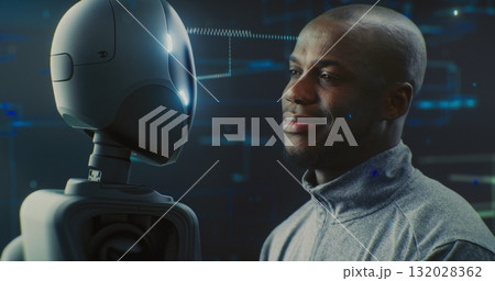 Guy Smiling Warmly While Looking Futuristic Robot With AI and Shiny Details 132028362