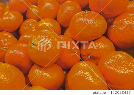 Abundance of bright orange fruits. Detailed texture of healthy, vitamin-rich mandarin or clementines Abundance of bright orange fruits. Detailed texture of healthy, vitamin-rich mandarin or clementines 132028437