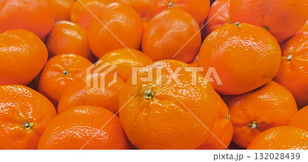 Abundance of bright orange fruits. Detailed texture of healthy, vitamin-rich mandarin or clementines Abundance of bright orange fruits. Detailed texture of healthy, vitamin-rich mandarin or clementines 132028439