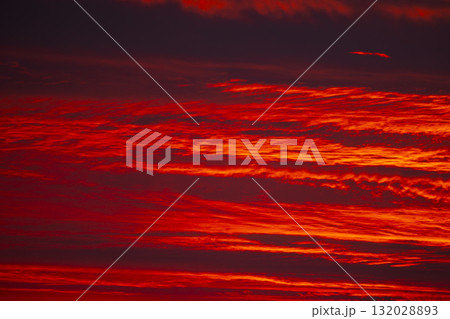 Evening sky displaying dramatic red and crimson clouds Evening sky displaying dramatic red and crimson clouds 132028893