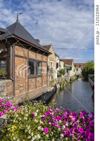French village canal flowing past historic buildings and blooming flowers French village canal flowing past historic buildings and blooming flowers 132028968