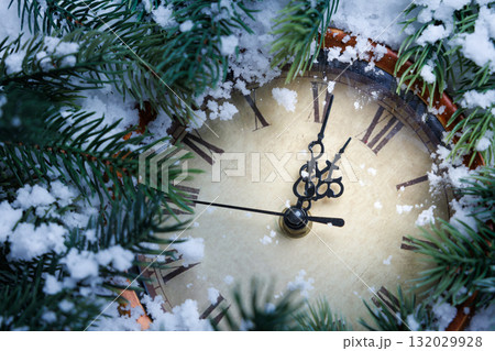 cozy holiday scene with clock, snowdusted fir branches with festive clock and berries scene cozy holiday scene with clock, snowdusted fir branches with festive clock and berries scene 132029928