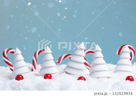 snowy christmas imagery with candies, decorative winter scene featuring candy canes and ornaments 132029938