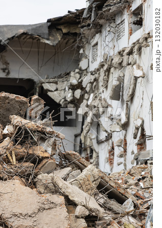 Demolition process in urban area shows debris and dismantled structure during building removal Demolition process in urban area shows debris and dismantled structure during building removal 132030182
