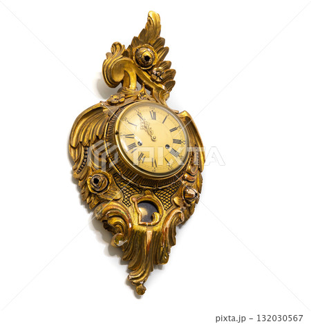 Vintage gilded clock isolated on white background featuring intricate floral carvings 132030567