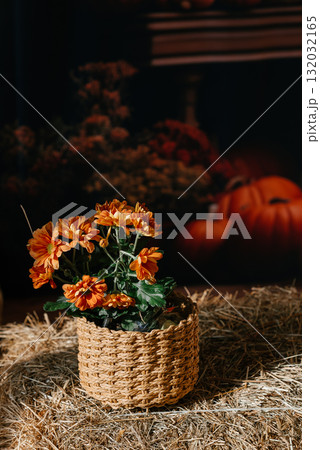 Rustic Basket with Orange Flowers on Straw Background Rustic Basket with Orange Flowers on Straw Background 132032165