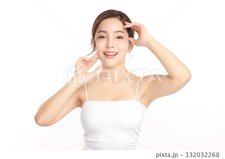 A beautiful young Asian woman with clean, fresh skin against a white background. Skincare, facial treatment, cosmetology, beauty, and spa. An elegant portrait of an Asian woman. A beautiful young Asian woman with clean, fresh skin against a white background. Skincare, facial treatment, cosmetology, beauty, and spa. An elegant portrait of an Asian woman. 132032268