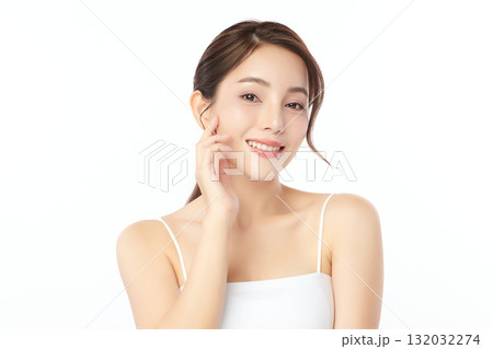 A beautiful young Asian woman with clean, fresh skin against a white background. Skincare, facial treatment, cosmetology, beauty, and spa. An elegant portrait of an Asian woman. A beautiful young Asian woman with clean, fresh skin against a white background. Skincare, facial treatment, cosmetology, beauty, and spa. An elegant portrait of an Asian woman. 132032274