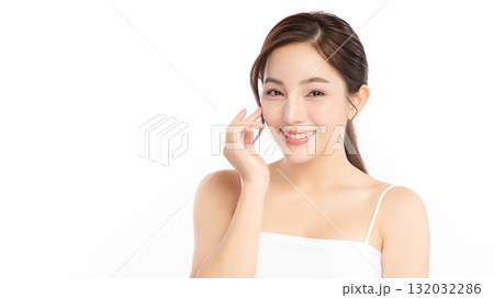 A beautiful young Asian woman with clean, fresh skin against a white background. Skincare, facial treatment, cosmetology, beauty, and spa. An elegant portrait of an Asian woman. 132032286