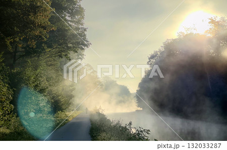 At Sunrise, the Misty River is Surrounded by Beautiful Lush Foliage and Natures Splendor At Sunrise, the Misty River is Surrounded by Beautiful Lush Foliage and Natures Splendor 132033287