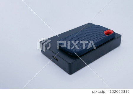 Two External SSD and HDD Drives on White Background Two External SSD and HDD Drives on White Background 132033333