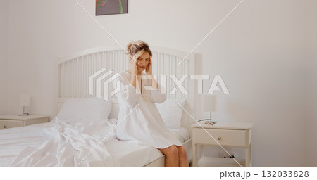 Pregnant woman feeling unwell having pain in her temples massaging them while in bedroom. Pregnant woman feeling unwell having pain in her temples massaging them while in bedroom. 132033828
