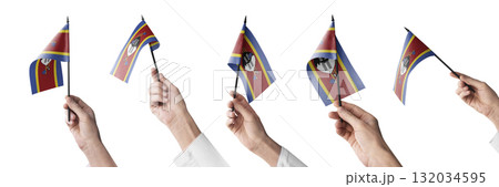 The Swaziland flag in hand in different angles on a white background 132034595