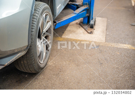 Close-up of a car rear wheel before tire replacement. Seasonal tire change for winter preparation in Czech Republic. Close-up of a car rear wheel before tire replacement. Seasonal tire change for winter preparation in Czech Republic. 132034802