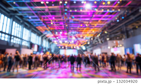 Large event crowd, diverse people, colorful lights, indoor venue, blurred background Large event crowd, diverse people, colorful lights, indoor venue, blurred background 132034920