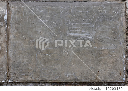Worn concrete wall with scratches in urban outdoor setting 132035264