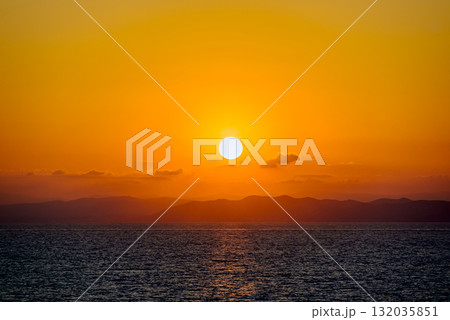 Beautiful orange sunrise sky over the sea horizon. Summer golden hour. Beautiful orange sunrise sky over the sea horizon. Summer golden hour. 132035851