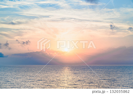 Beautiful orange sunrise sky over the sea horizon. Summer golden hour. 132035862