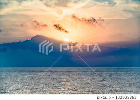 Beautiful orange sunrise sky over the sea horizon. Summer golden hour. Beautiful orange sunrise sky over the sea horizon. Summer golden hour. 132035863