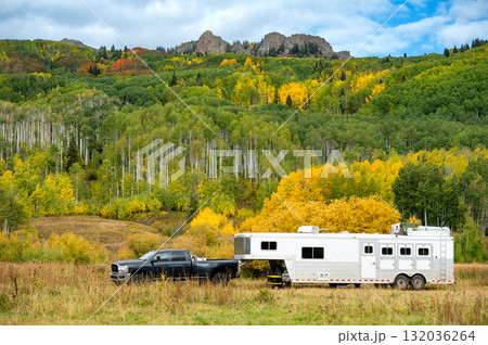 Pickup truck and travel trailer parking among colorful fall foliage of Kebler pass, Colorado, USA Pickup truck and travel trailer parking among colorful fall foliage of Kebler pass, Colorado, USA 132036264